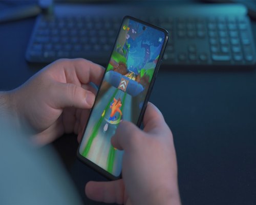 Smartphone with a vivid adventure game clearly displayed on the screen