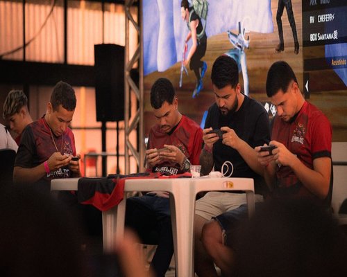 Players using smartphones with colourful games visible on the screens