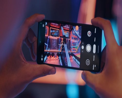 Large smartphone displaying a colourful CROWN adventure game on its screen