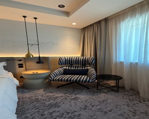 Modern Melbourne hotel room with a comfortable gaming-ready lounge
